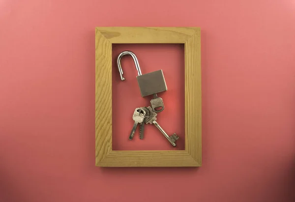 Lock and key isolated by pink colour background.