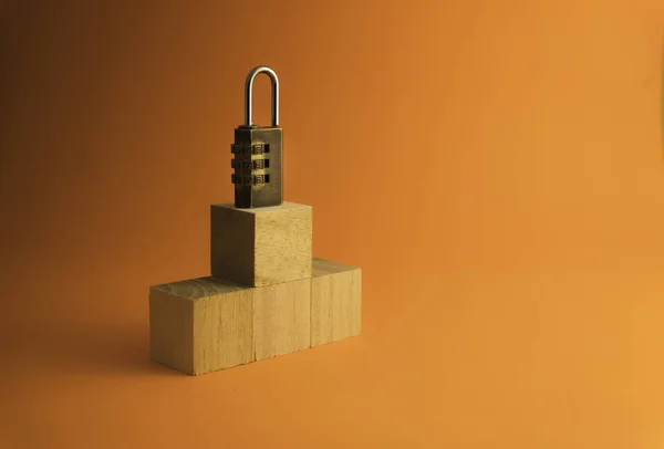 Combination padlock  isolated on orange background.