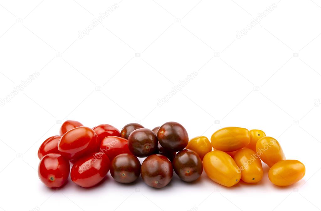 yellow, red and brown cherry tomatoes on a white isolated 