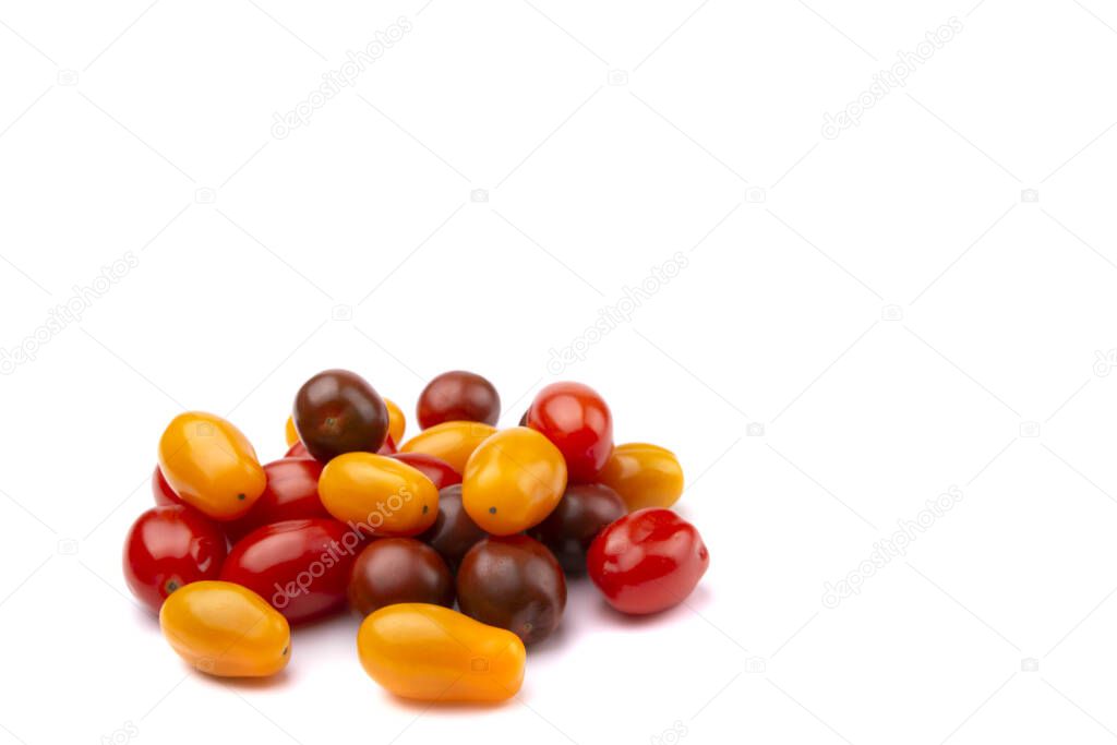 yellow, red and brown cherry tomatoes on a white isolated 