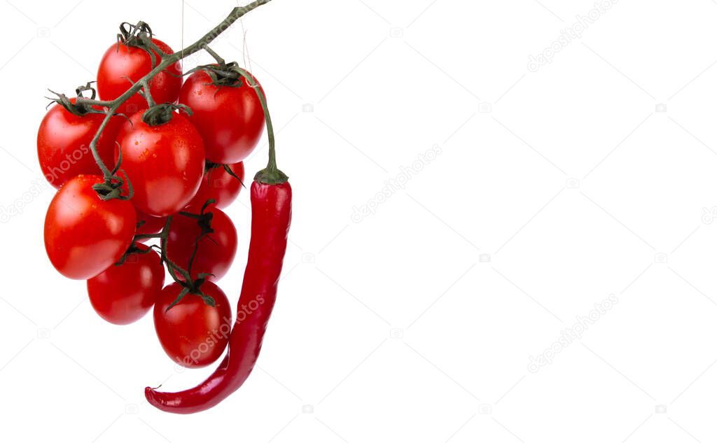 cherry tomatoes and a pod of red chilli on a white isolated background