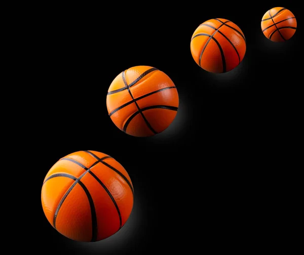 Balones de baloncesto voladores sobre un fondo negro aislado, espacio para texto — Foto de Stock