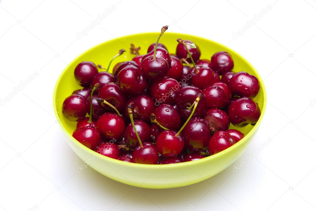 Fresh cherries with water drops in a bowl