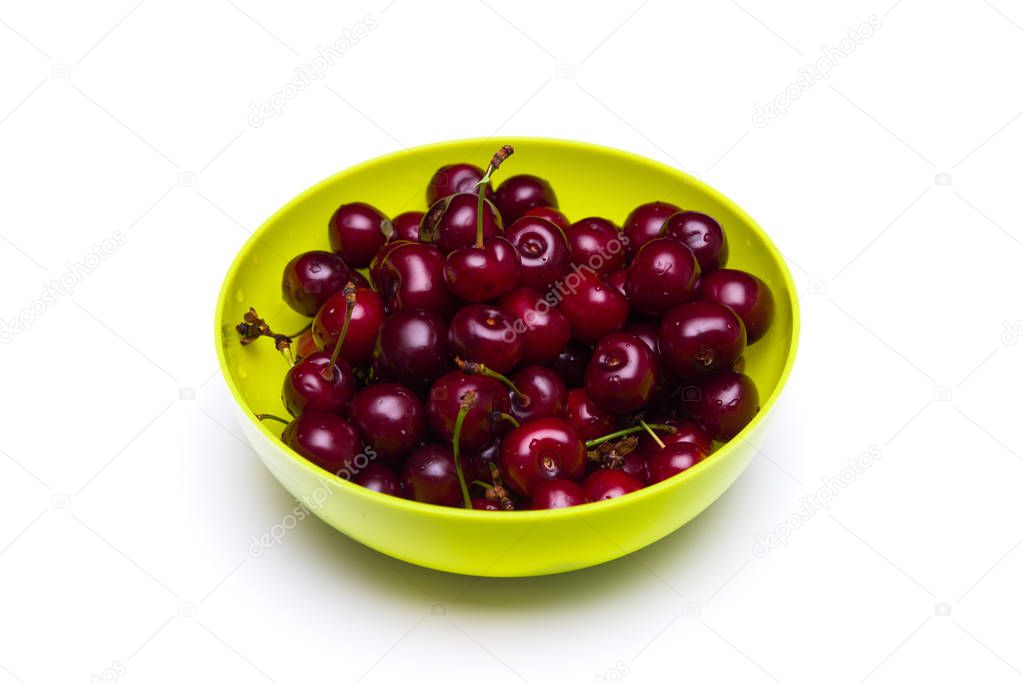 Fresh cherries with water drops in a bowl