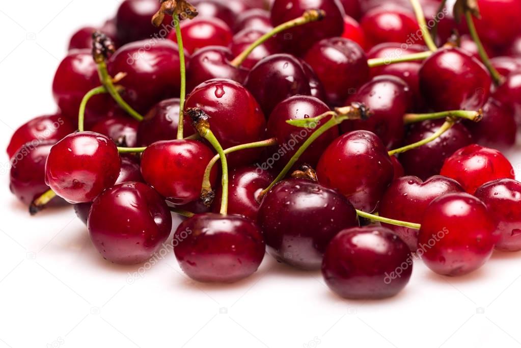Fresh cherries with water drops isolated on white background.