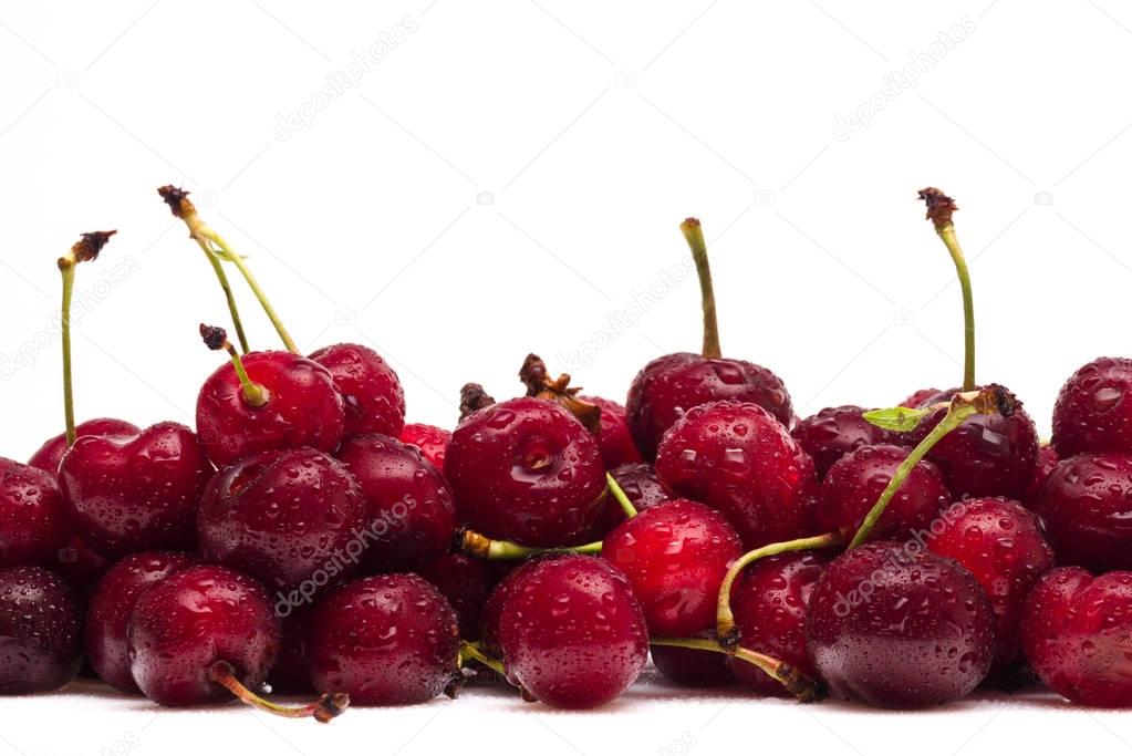 Wet cherries with water drops and soft light reflects