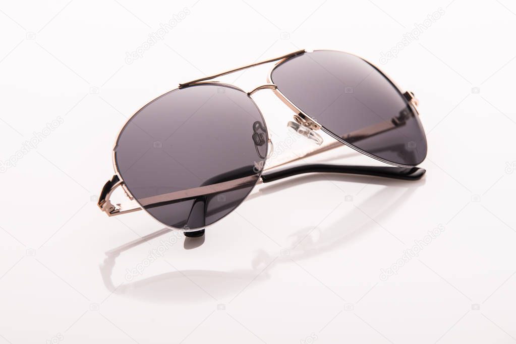 Sunglasses on a white surface.