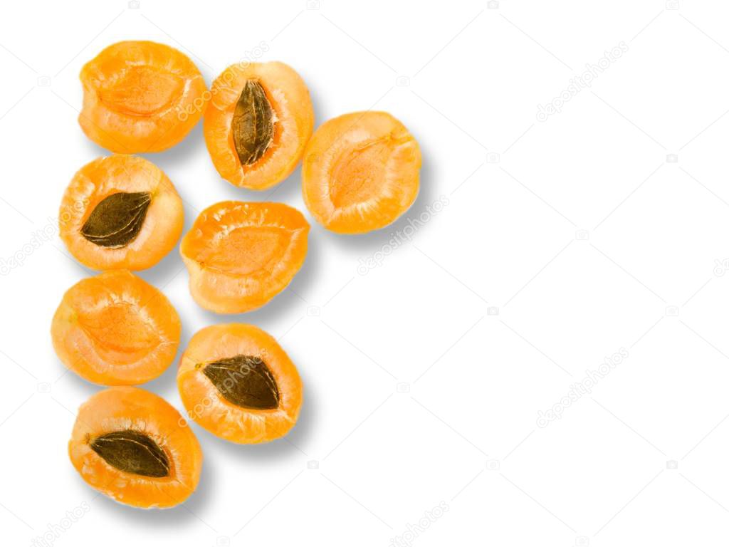 Apricot halves with seeds, prepared for cooking isolated on white with shadows. 