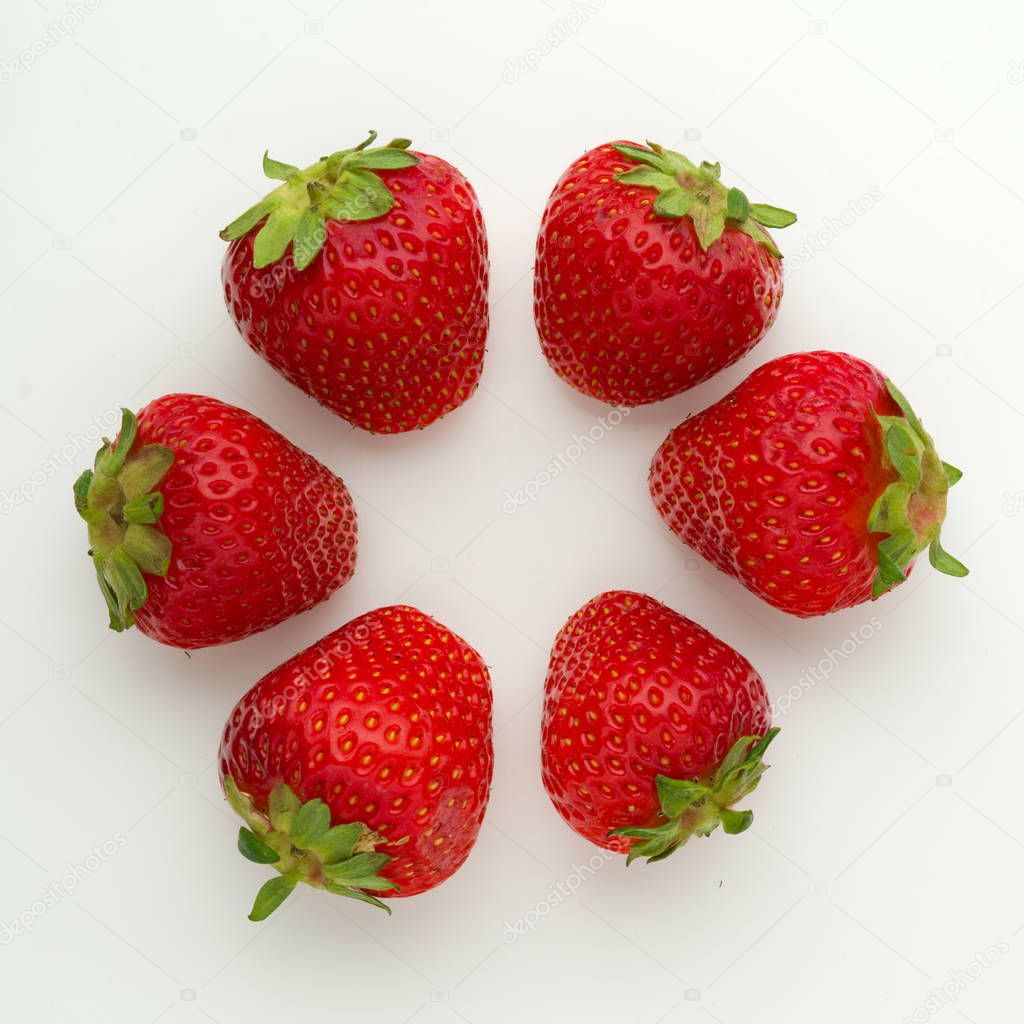Arranged ripe strawberries on white background. 