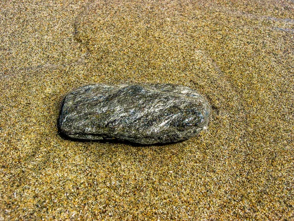 Stone submerged on the shore of the beach. — Stock Photo, Image