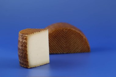 Cured Manchego cheese, derived from sheep's milk. clipart