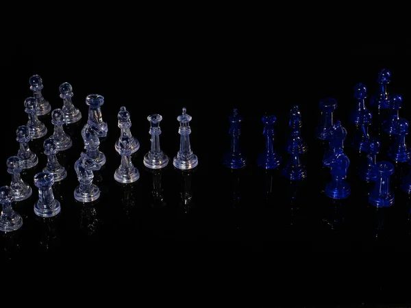 Chess pieces, strategy game. It is played on a board of 64 black and white squares.