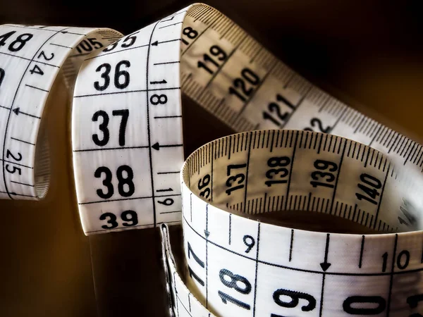 Tape measure, used by dressmakers and tailors to take measurements of the clothes to be made.