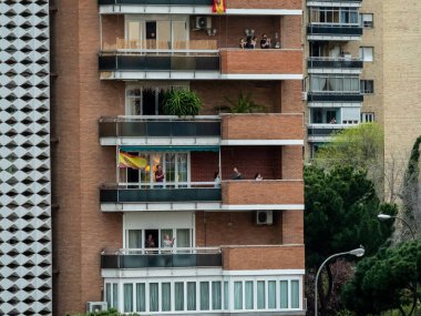 Madrid, İspanya - 29 Mart 2020: Covid-1 İspanya 'da alarm durumu. Madrid 'deki koronavirüs salgını her akşam saat 08: 00' de komşuları balkonlarına getirip bu epideyle savaşan doktorlar, hemşireler, polisler ve çalışanlara saygılarını sunar.