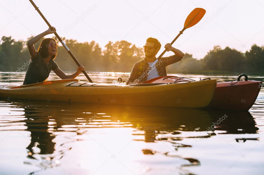beautiful couple kayaking on river together