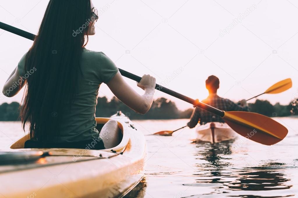 beautiful couple kayaking on river together