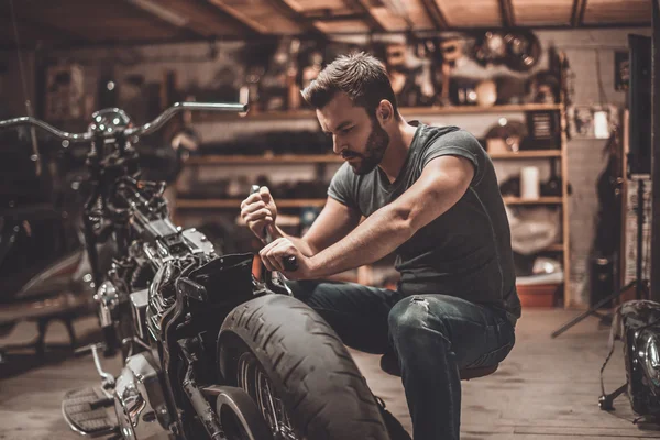 handsome young mechanic in garage