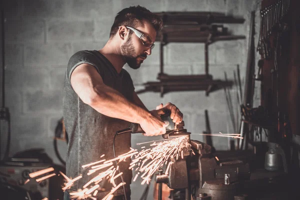 Handsome welder in garage — Stockfoto