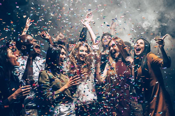 People dancing at party with confetti — Stock Photo, Image