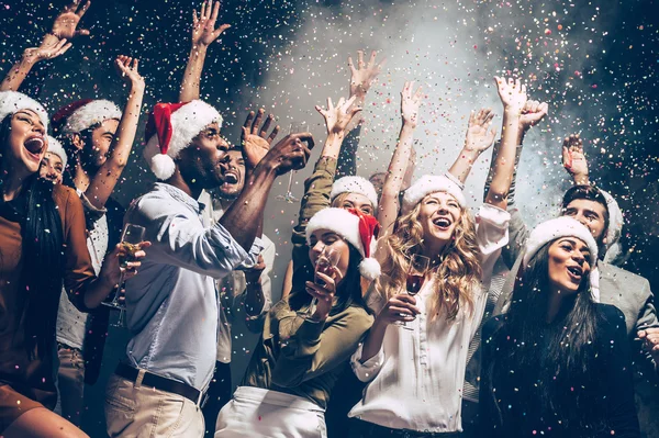 People dancing in Santa hats — Stock Photo, Image