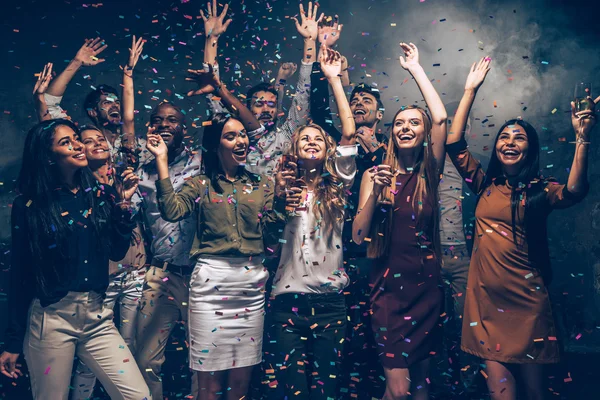 People dancing at party with confetti — Stock Photo, Image