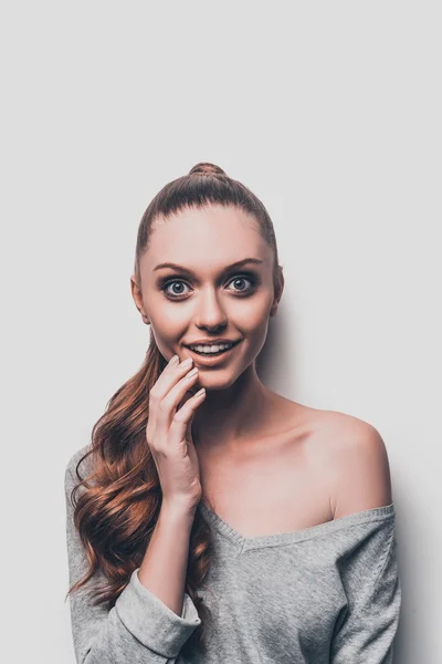 Surprised young woman touching face — Stock Photo, Image