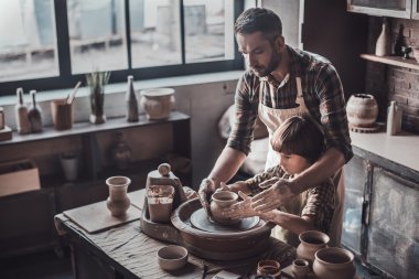 father and son making ceramic pot clipart