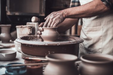 man making pot on pottery wheel clipart