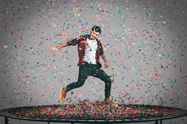 happy man jumping on trampoline