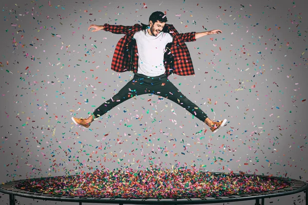 happy man jumping on trampoline