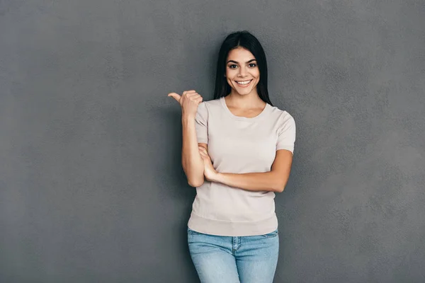 Attractive brunette woman pointing finger — Stock Photo, Image