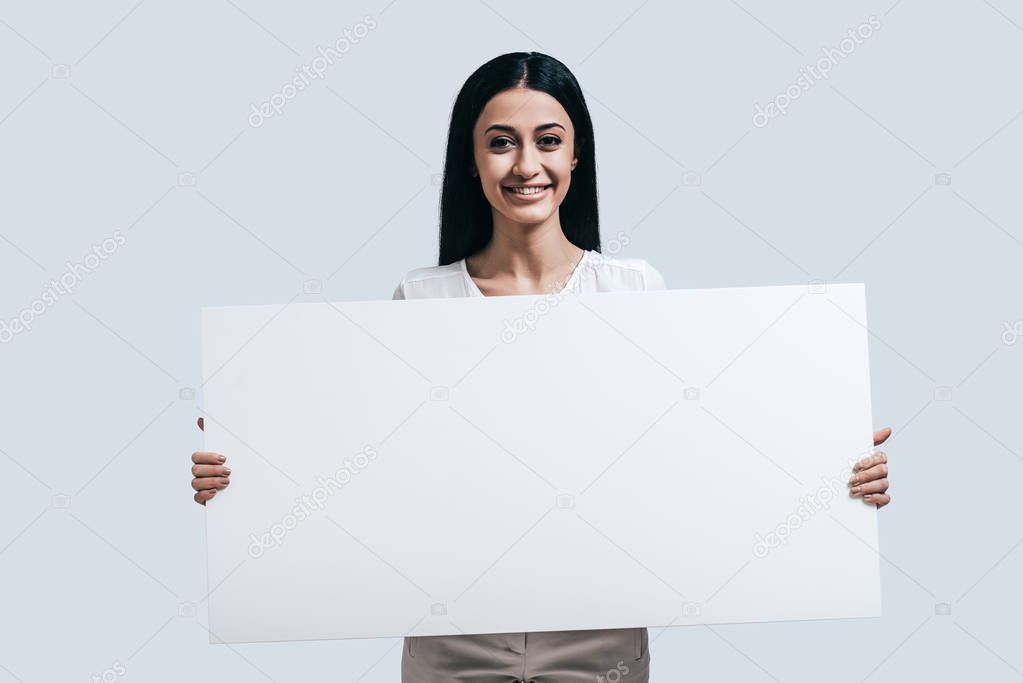Woman holding blank flipchart