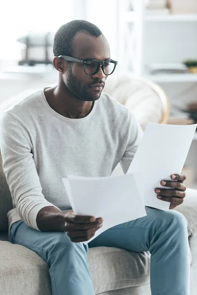 Man in glasses reading documents — Stock Photo, Image
