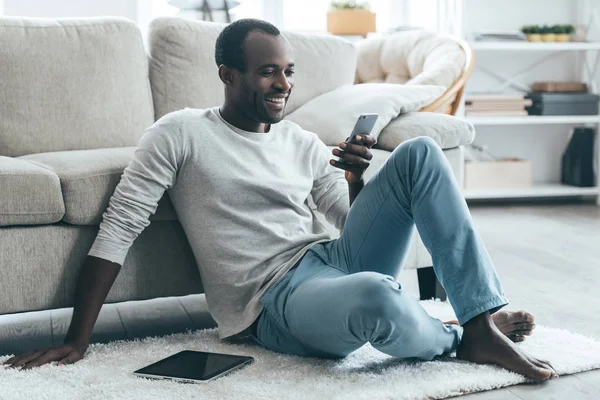 Man tittar på telefon och leende — Stockfoto