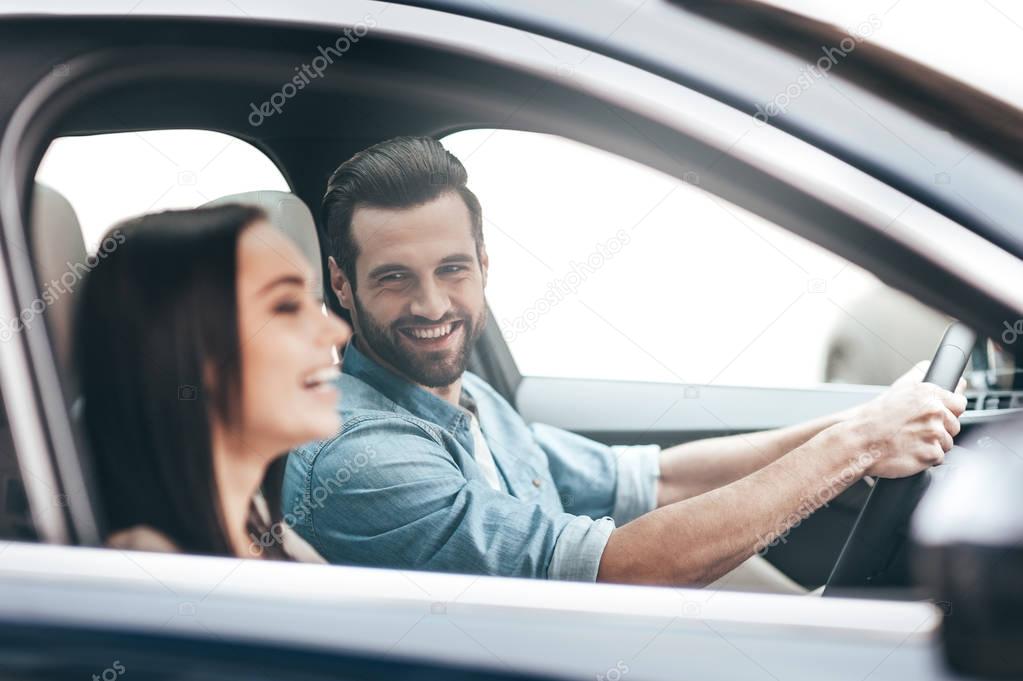 Beautiful couple driving car