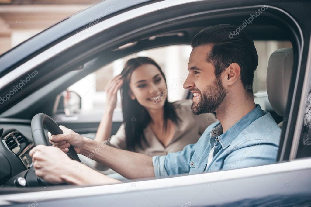 Beautiful couple driving car