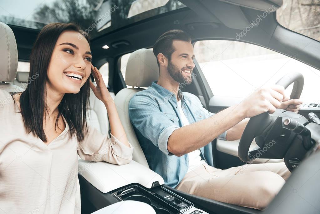 Beautiful couple driving car