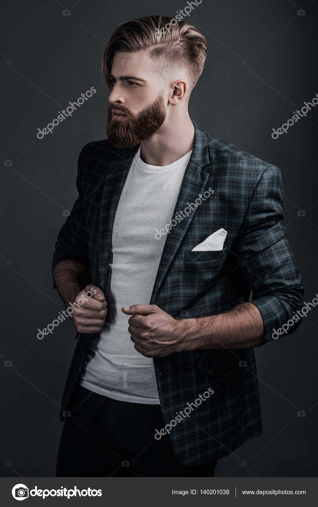 Premium Photo | Man holds coat in hand and poses to the camera in ellegant  dark suit. fasion businessman with modern business center in the background.