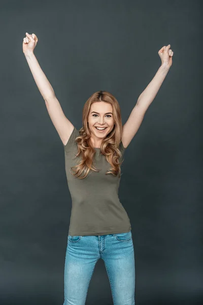 Beautiful woman keeping arms raised — Stock Photo, Image