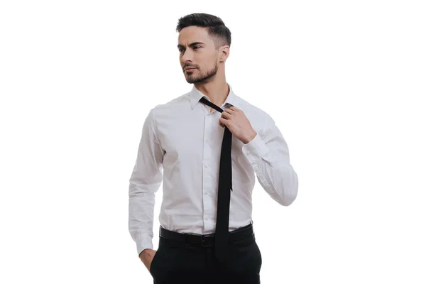 Young businessman adjusting necktie — Stock Photo, Image