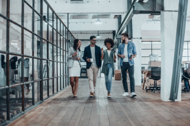 business people walking in modern office clipart