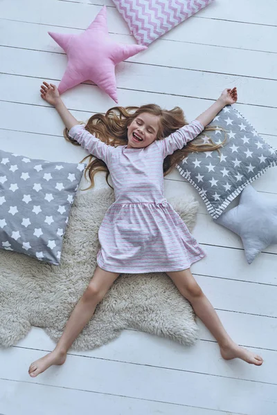 Cute little girl smiling and lying — Stock Photo, Image
