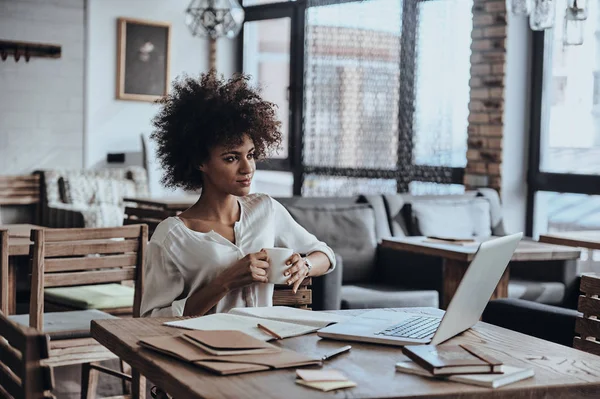 African woman sitting in cafe — Stock Photo, Image