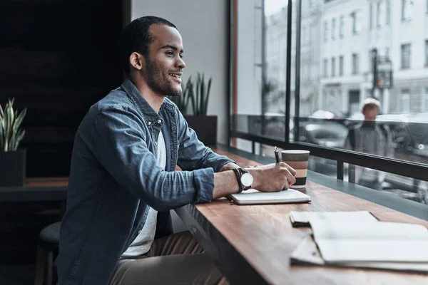 Handsome student writing in diary — Stock Photo, Image