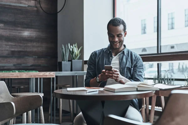 handsome man browsing smartphone