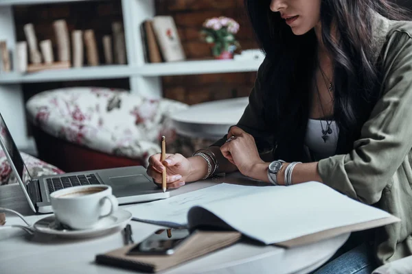 Thoughtful woman writing notes in diary Royalty Free Stock Photos