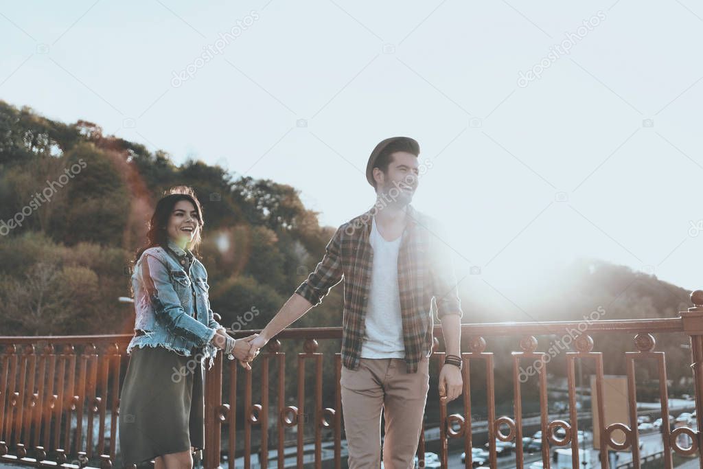 Beautiful young couple holding hands 
