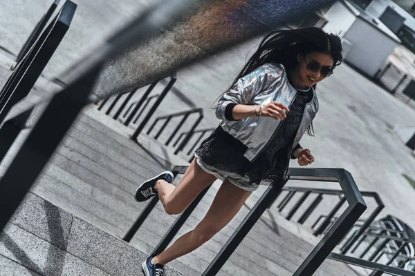 asian woman on stairs in city