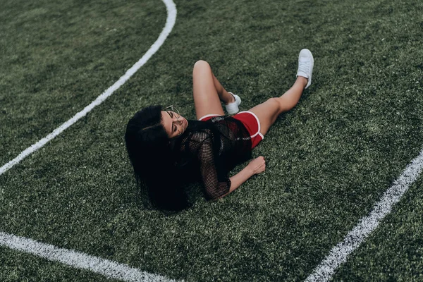 Žena uvolňující na fotbalovém hřišti — Stock fotografie
