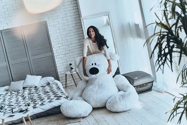 Vrouw zittend op grote teddybeer — Stockfoto